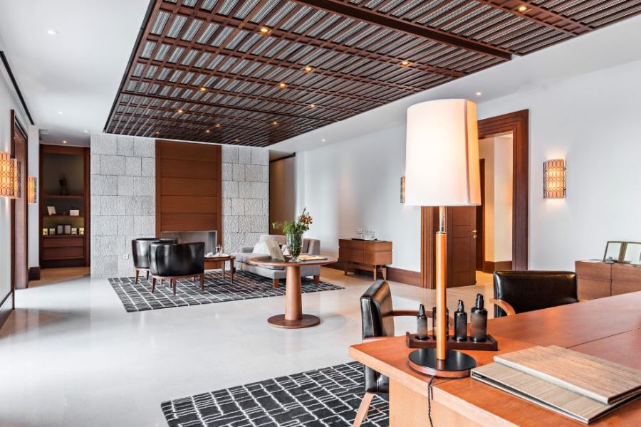 Modern clothing showroom with polished tile floor, display shelves, and seating area
